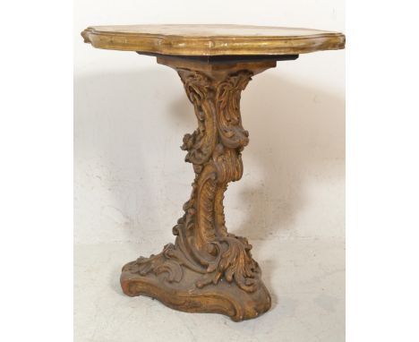 A 20th century Italian faux marble carved wooden centre / lamp table. The wooden base gilded and fashioned to the shape of a 