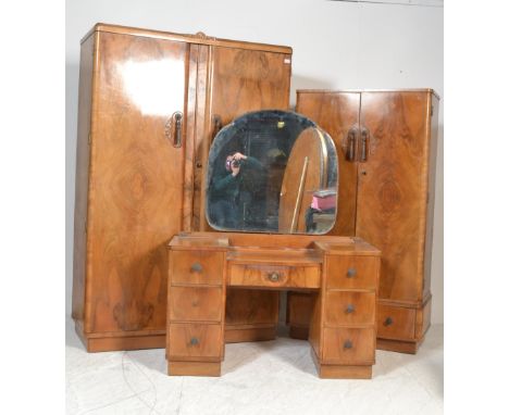 A 1930's Art Deco walnut bedroom suite comprising a drop centre walnut dressing table with good shaped mirror together with a