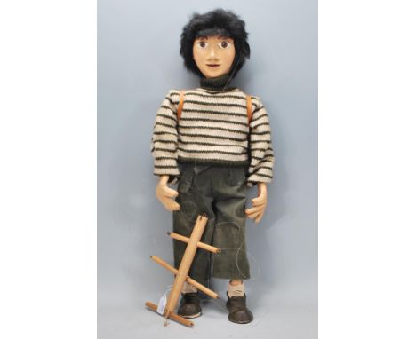A vintage 20th Century hand made wooden puppet moulded as young boy having a violin and backpack. Measures 58cm long.&nbsp;&n