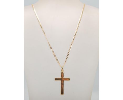 A lage 9ct gold hallmarked crucifix cross pendant set to a 9ct gold curb link necklace. Weighing 6.3g, pendant measures 4.5cm