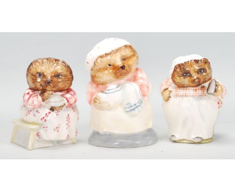 A group of three ceramic Beatrix potter figurines to include Beswick' Mrs Tiggy Winkle' and 'Mrs Tiggy Winkle takes tea' toge