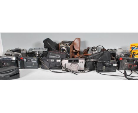 A collection of various cameras and lenses to include&nbsp;Topcon Unirex having a UV Topcor lens and a Topcon Wink S Mirror, 