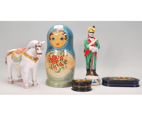 A collection of Russian ornaments to include a large set of russian dolls beung hand painted with floral sprays, a ceramic ho