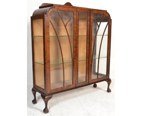 A 1930's Queen Anne revival mahogany china display cabinet being raised claw and ball feet with cabriole legs. Shaped display