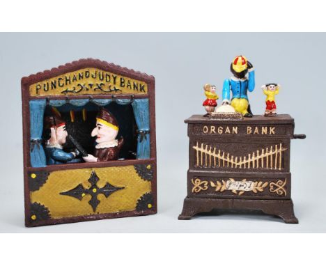 Two vintage style novelty mechanical money banks to include a Punch and Judy puppet theatre bank and an organ bank having mec