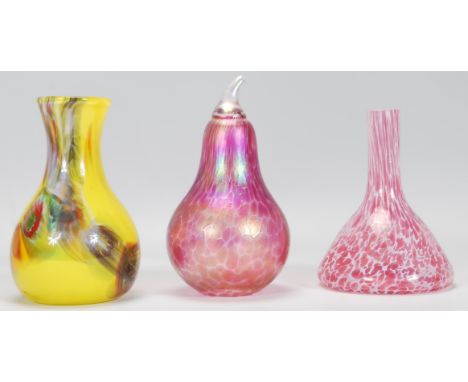 A group of three vintage retro studio art glass vases to include a Heron pink pear paperweight having an iridescent finish, a