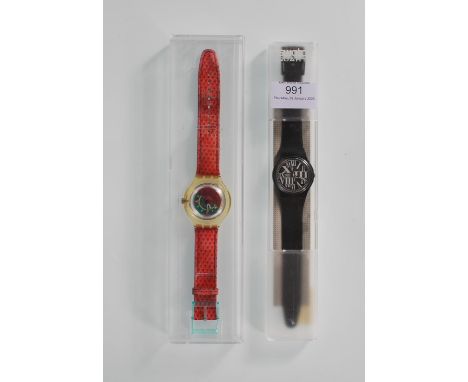 Two swatch wrist watches to include one on a black rubber strap with white roman numerals to the face and a Scuba Scuba watch