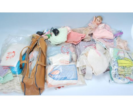 A collection of vintage dolls woolen clothing, shoes etc together with accessories, dolls contained within a vintage Wharfeda