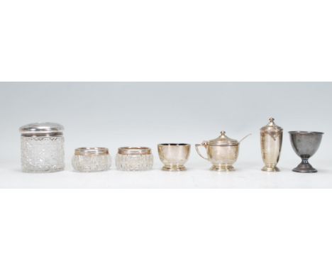 A selection of silver hallmarked cruet items to include a lidded mustard pot, table salt and pepperette (makers marks S&amp;M