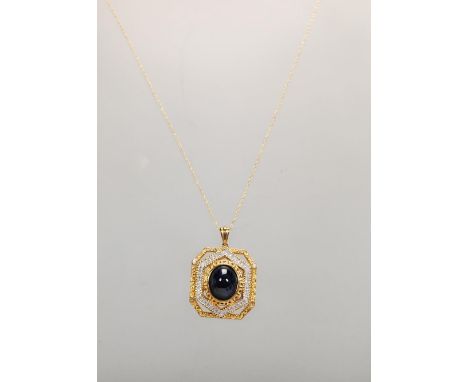 A 9ct gold hallmarked Indian pendant necklace, the pendant set with central cabochon stone bordered by white stones and seed 