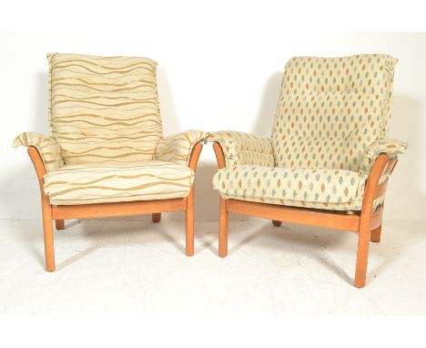 A pair of large Ercol Renaissance light elm armchairs complete with upholstered cushions in very good condition, the frames w