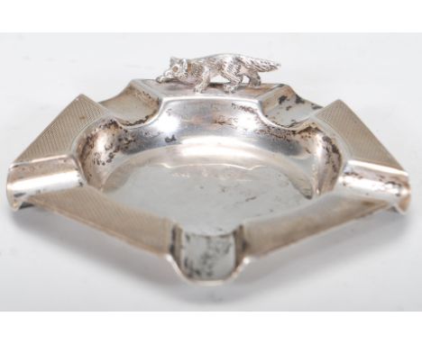 A silver hallmarked and engine turned cigar ashtray with applied sculptural silver fox to the edge, Birmingham assay mark dat