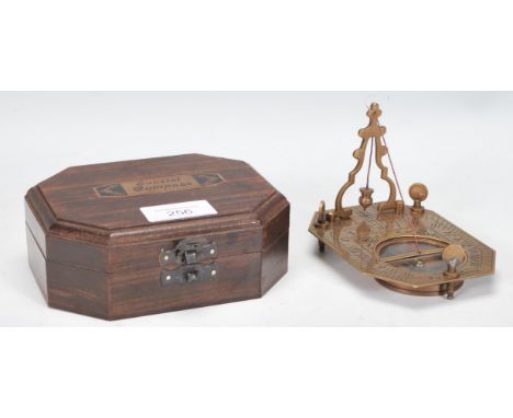 A 20th Century cased brass Sundial Compass, the compass set within the folding metamorphic sundial, marked Cox London.
