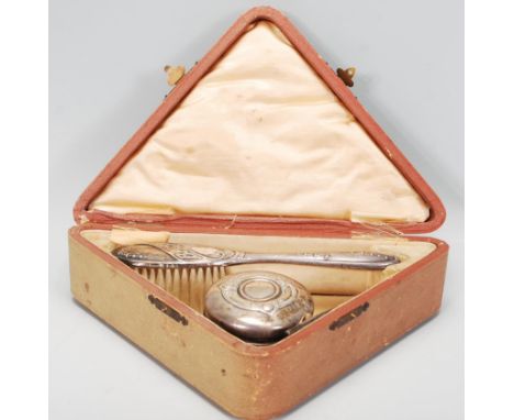 A silver hallmarked three piece Christening set within its original leather case of triangular form, contents to include lidd