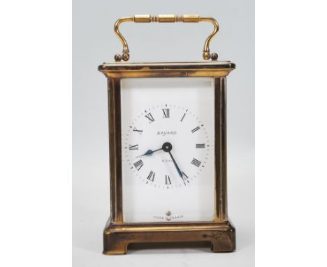 A 20th Century French Bayard 8 day carriage clock being brass cased with three sides set with glazed panels, having a white e