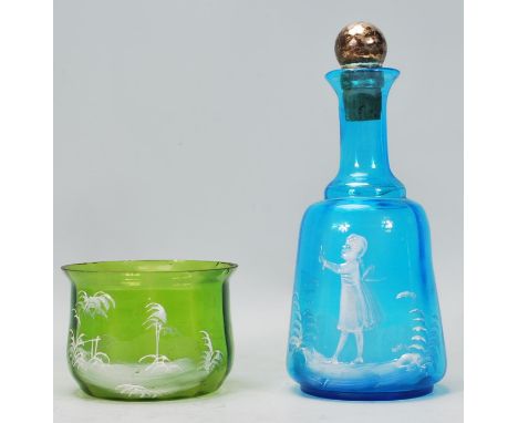 A 19th Century blue glass decanter in the manor of Mary Gregory having&nbsp;hand decorated scene depicting a girl playing wit
