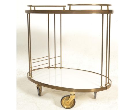 A 1950's retro vintage brass and laminate two tier serving / drinks / cocktail trolley having a ellipse shape and brass wire 