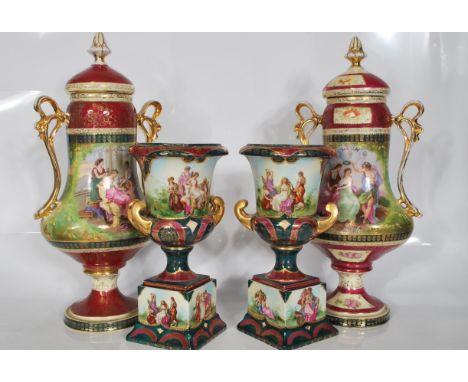 A matching pair of early 20th Century&nbsp;Continental twin handled ceramic urn vase having burgundy ground&nbsp;with central