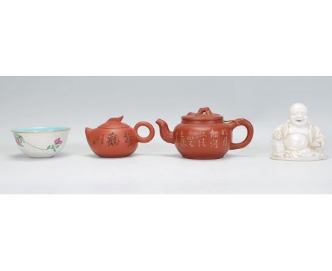 A collection of mixed 20th Century Chinese ceramic wares to include a white glazed laughing happy Buddha having apllied mould