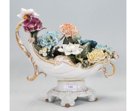 A 20th Century Italian Capodimonte ceramic flower basket figurine having ceramic modelled flowers within a scrolled form plan