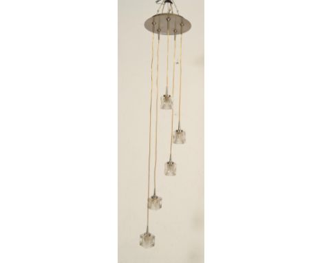 A contemporary pendant ceiling light fixture having five glass ice cube lights each at graduating heights.&nbsp;