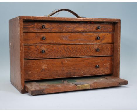A vintage 20th Century oak engineers case, fall front revealing lined drawers containing engineers tools to include an Imperi