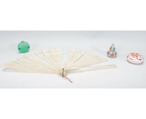 A collection of vintage Chinese items to include a carved fret pierced hand fan, a green jade style snuff bottle, a double go