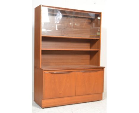 A retro&nbsp; 20th century teak wood mid century highboard - credenza having a plinth base with double door cupboard. Above, 