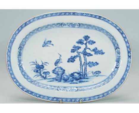 A 19th Century Chinese blue and white ceramic serving plate / platter of rectangular canted form, hand painted with cranes an