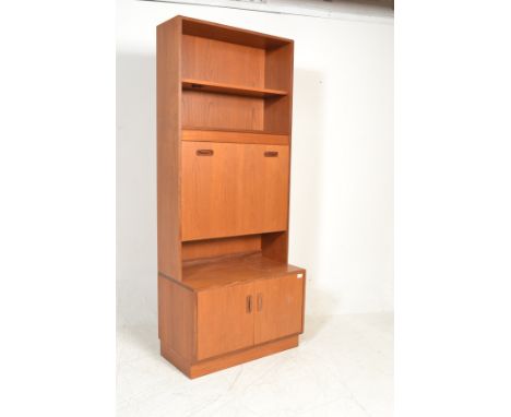 A vintage retro mid 20th Century G Plan red label teak wood wall unit consisting of twin door cupboard with fall front desk a