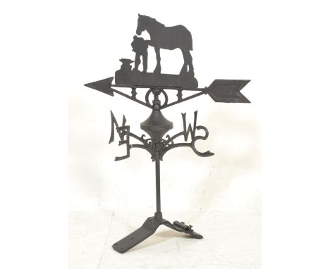 A 20th Century cast iron weather vane having North South East and West appendages with rotating arrow to top decorated with a