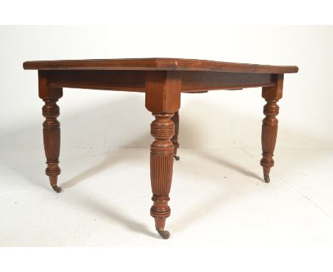 A Victorian 19th century mahogany wind out extending table. Raised on ceramic brown castors with reeded and turned legs. The 