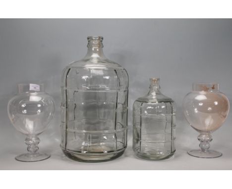 A pair of vintage style pedestal glass sweet jars together with two graduating glass olive / oil jars / demi Johns. Measure 4
