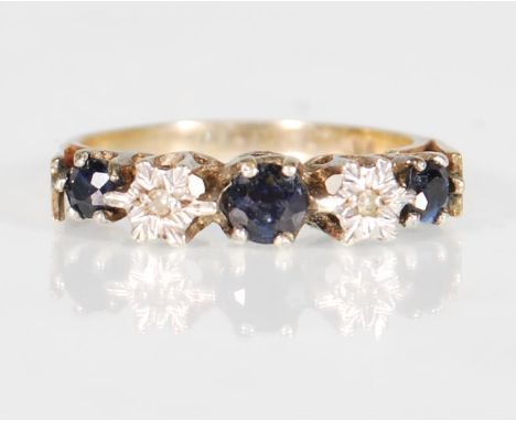 A 9ct yellow gold ladies dress ring&nbsp; set with three blue round cut stones interspersed with two illusion set diamonds on