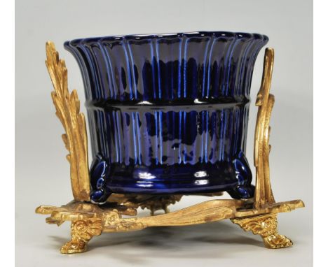 A gilt metal rococo planter stand together with cobalt blue ceramic glazed plant pot.&nbsp; Measures 20cm high.