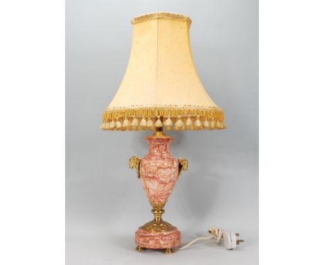 A 20th century Adams revival red and white ripple marble veined table lamp with gilded feet and rams head masks with shade at