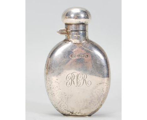 An Antique Victorian silver flask with the monogram "RLR".&nbsp;Makers mark unreadable. Hallmark reads 1900 Birmingham. Weigh