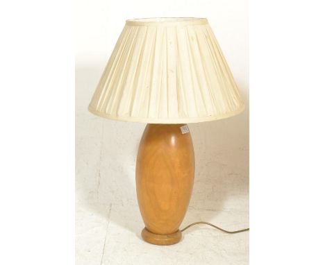 A 20th century hand turned retro wooden table lamp, possibly laburnum wood being of bulbous form with shade atop