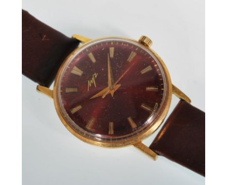 A vintage Russian Luch gentleman's gold plated wrist watch having a round red face with gilt baton markings to the chapter ri