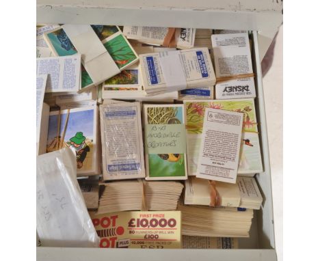 A Large collection of vintage and later cigarette and confectionery trade cards stored within a multi drawer filing cabinet. 