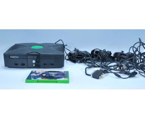 An original Xbox games console together with with three Xbox controllers, cables and The Sims.&nbsp;