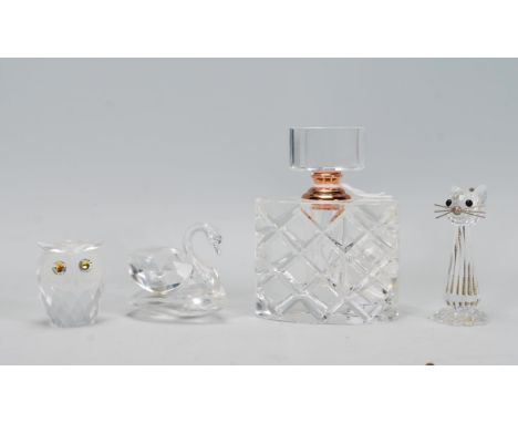 A group of three pieces of Swarovski ornamental figures to include one modelled as a swan, a mouse and an owl, all signed to 