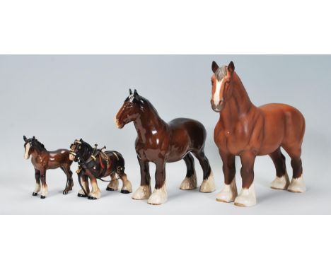 A group of Beswick ceramic horses to include a matte glazed shire horse with a ribbon plated into its mane, another shire hor