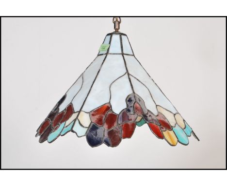 A vintage large 20th Century multi coloured leaded glass ceiling light fixture in the manner of Tiffany, of conical form havi