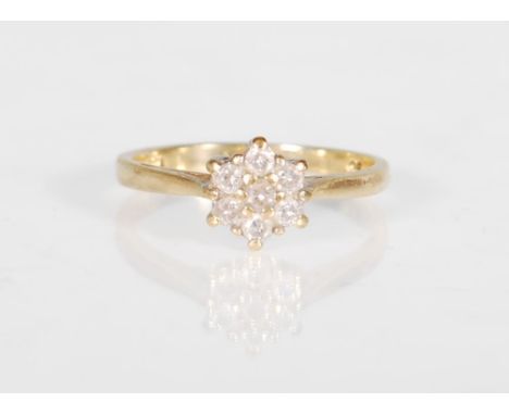 A hallmarked 9ct gold and diamond cluster ring. The ring having a cluster of 7 round brilliant cut diamonds. Estimated diamon