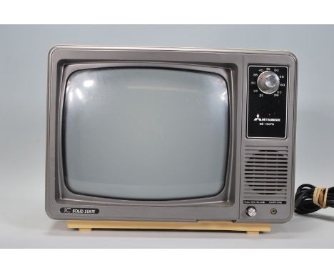 A vintage 1970's Mitsubishi BB 1207B IC solid state television set, case in cream plastic with volume dials to the front.&nbs