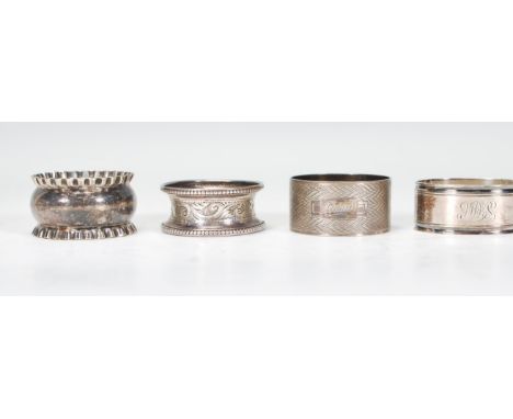 A harlequin set of four silver napkin rings to include an engine turned ring engraved Brian (hallmarked Birmingham 1938), a n