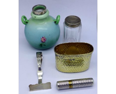 A silver flask cup, a silver food pusher, a silver lighter, a silver topped bottle and a silver rimmed vase