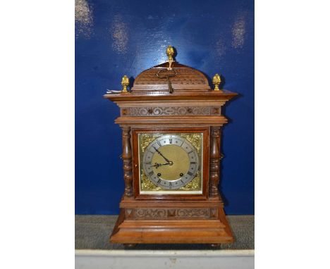 An early 20th Century continental Winterhalder and Hoffmeier mantel clock set in an architectural case with brass face and br