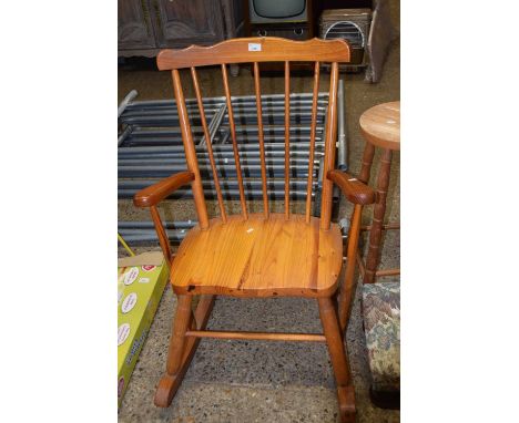 A pine stick back rocking chair